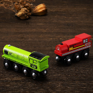 Two toy trains, one green and one red