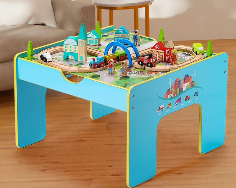 Children playing with a toy train set on a removable tabletop, which can be moved around.