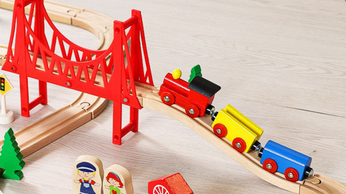 Wooden train set with red bridge and colorful trains