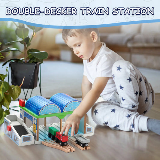 Child playing with a toy train set at a double-decker train station