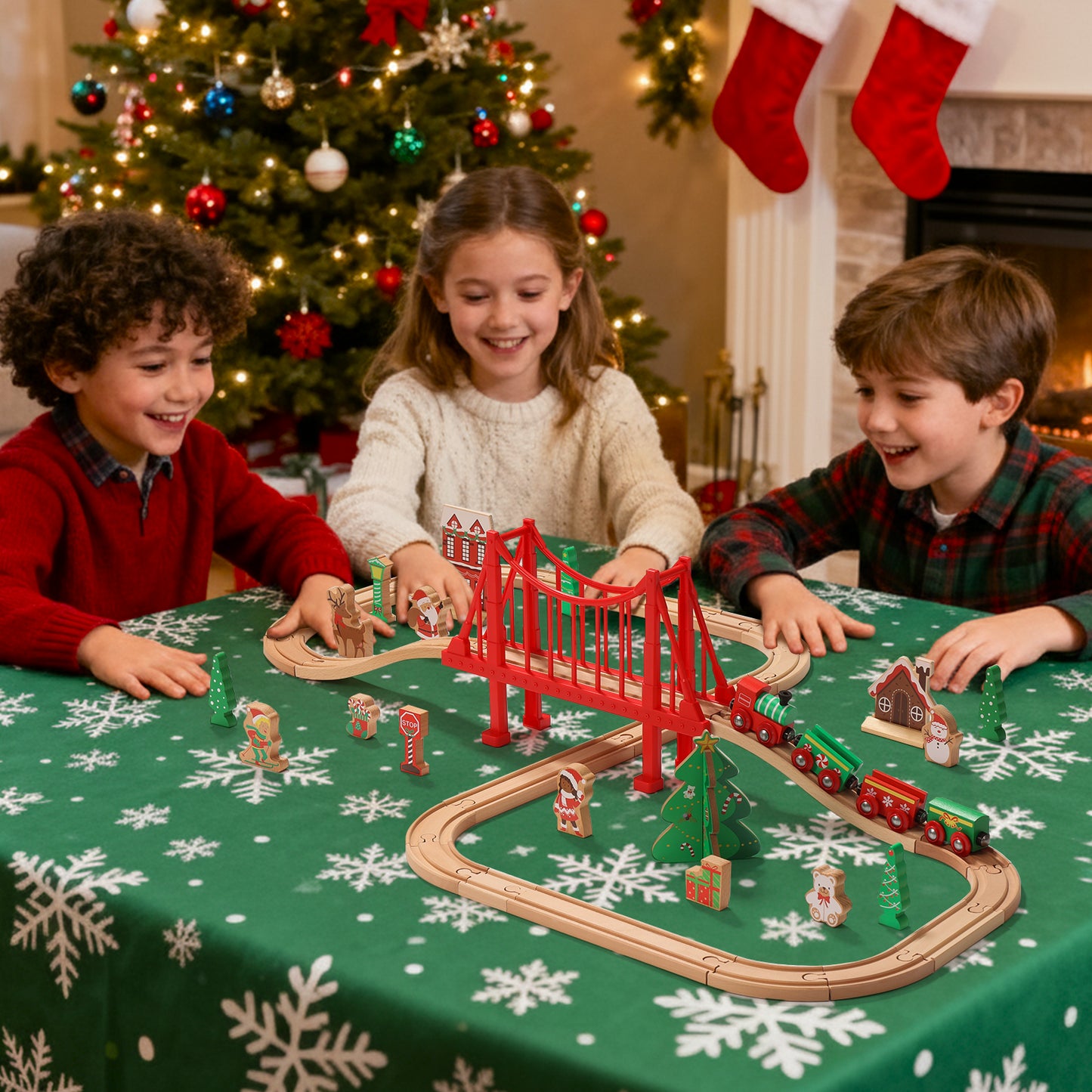 Children playing with a toy train set on a table decorated for Christmas.