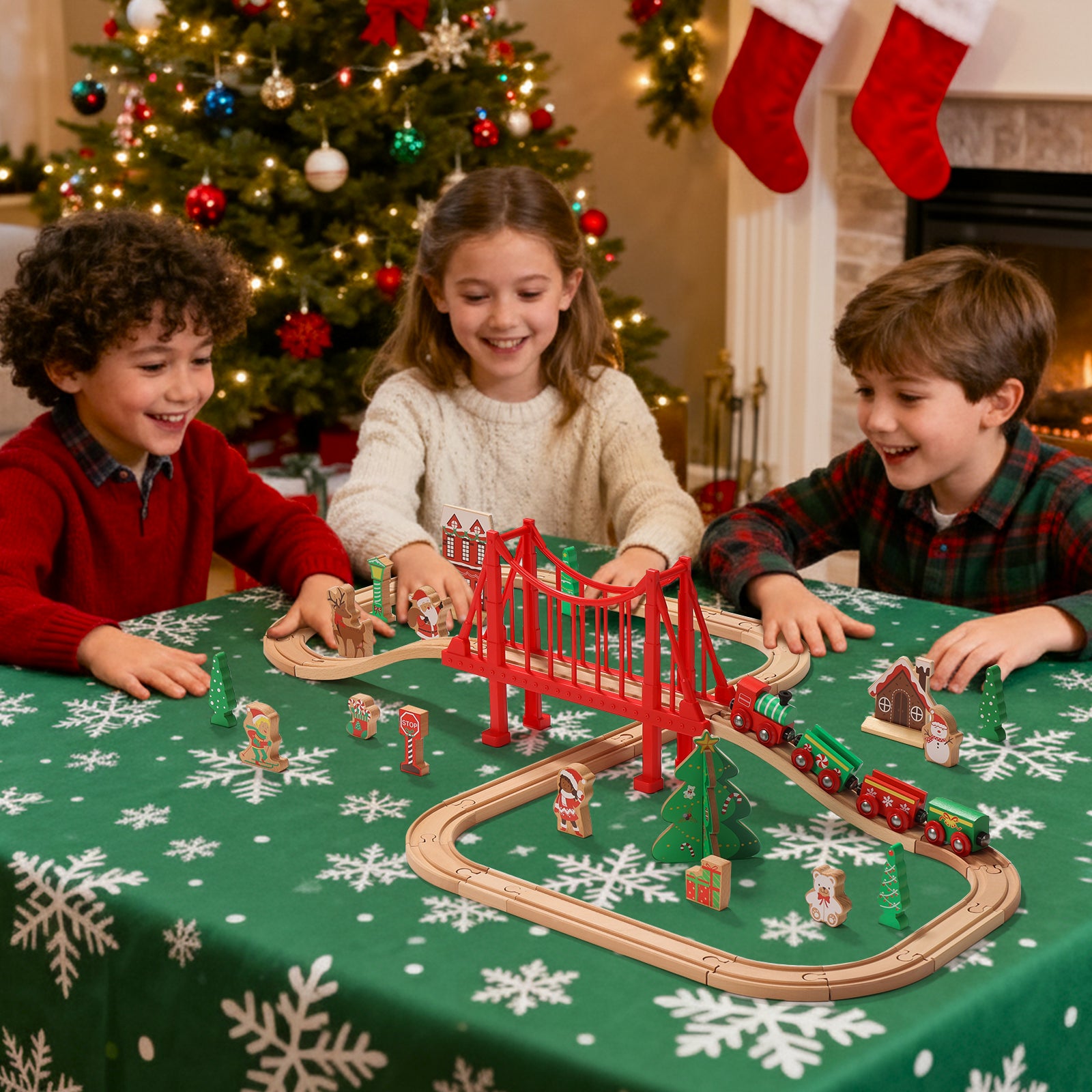 Children playing with a toy train set on a table decorated for Christmas.
