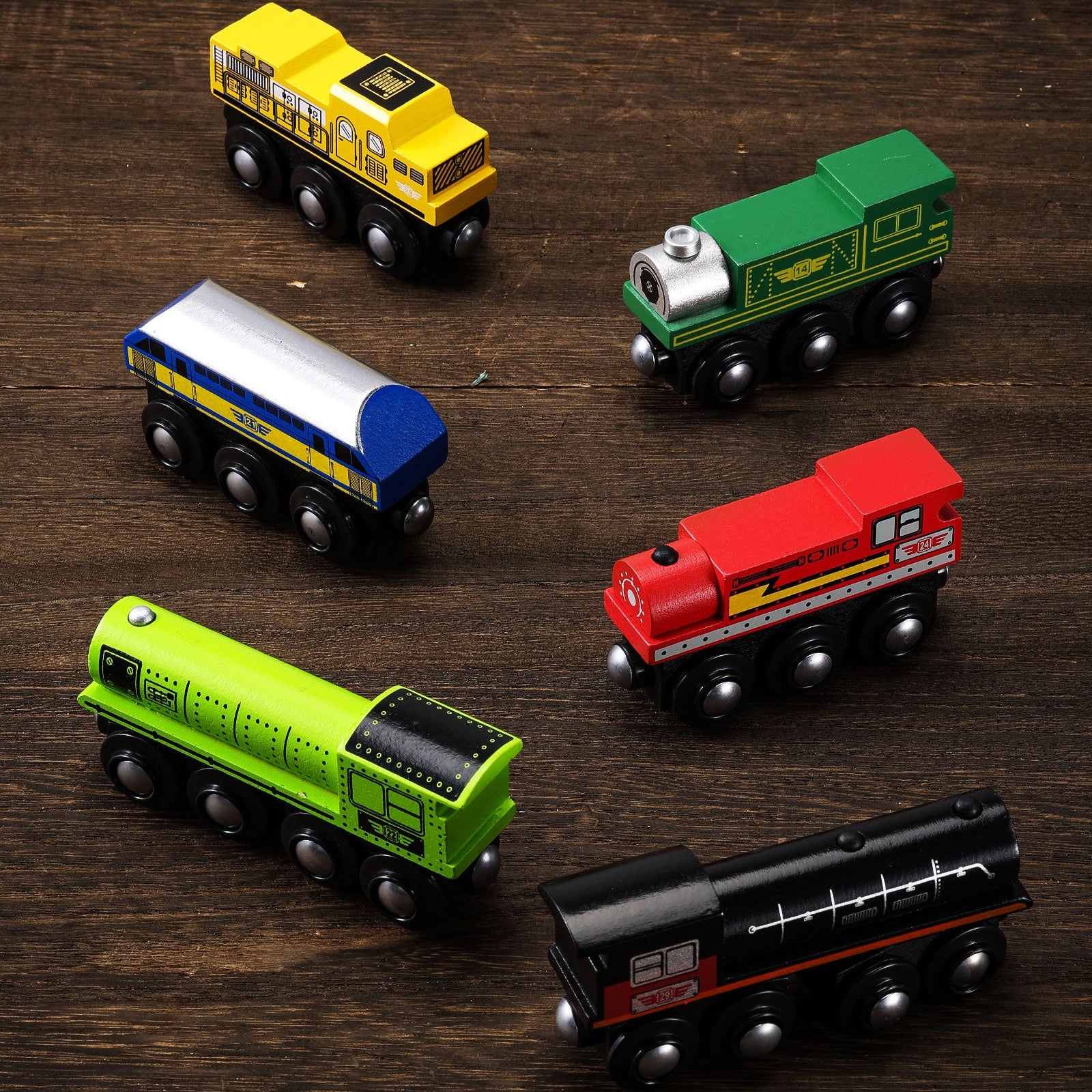 Set of toy trains made of natural solid wood on a wooden surface.