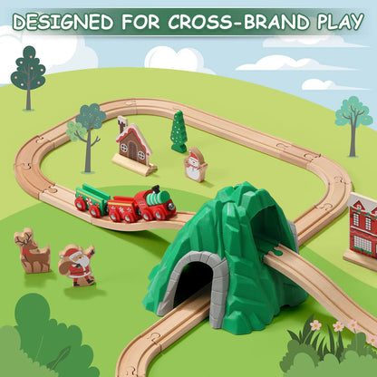 Toy train set with tracks, tunnel, and small buildings on a green landscape.