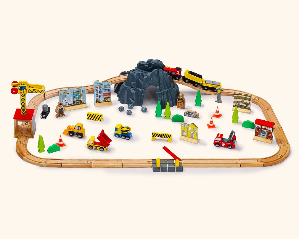 Toy train set with tracks and various train cars