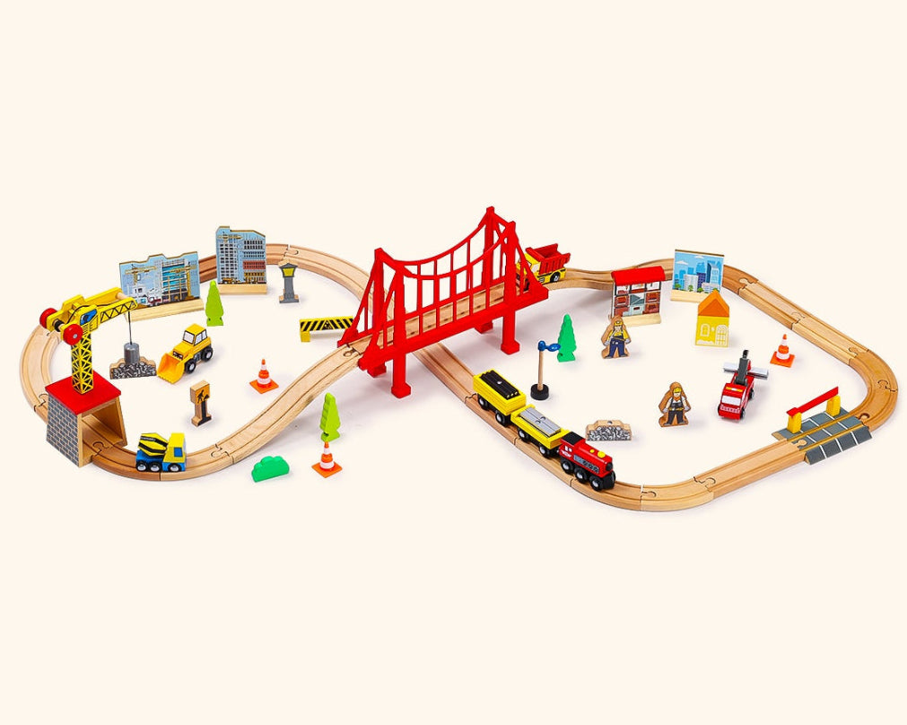 Toy train set with a bridge and various vehicles