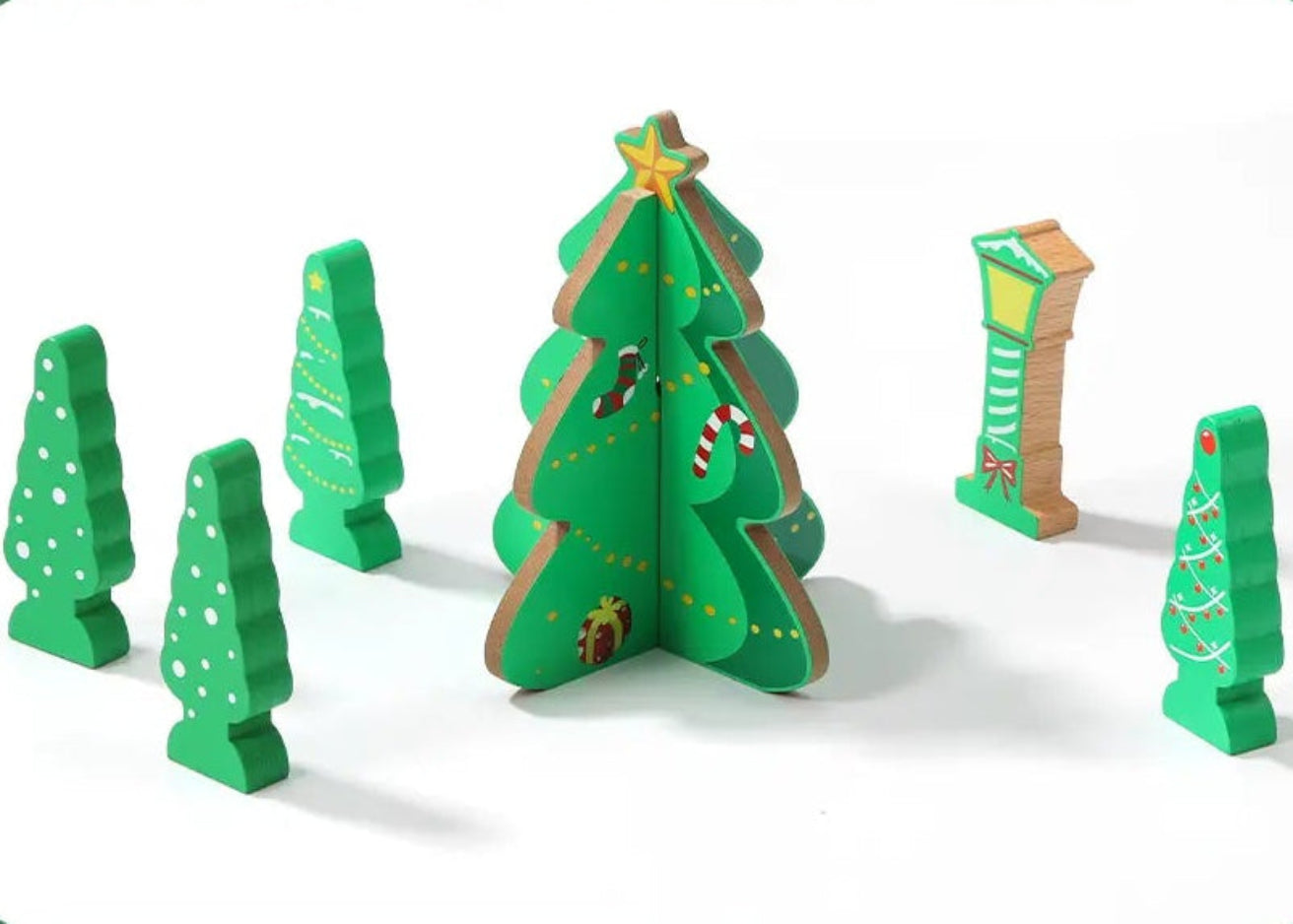 Set of Christmas-themed wooden toys including a train, houses, and trees