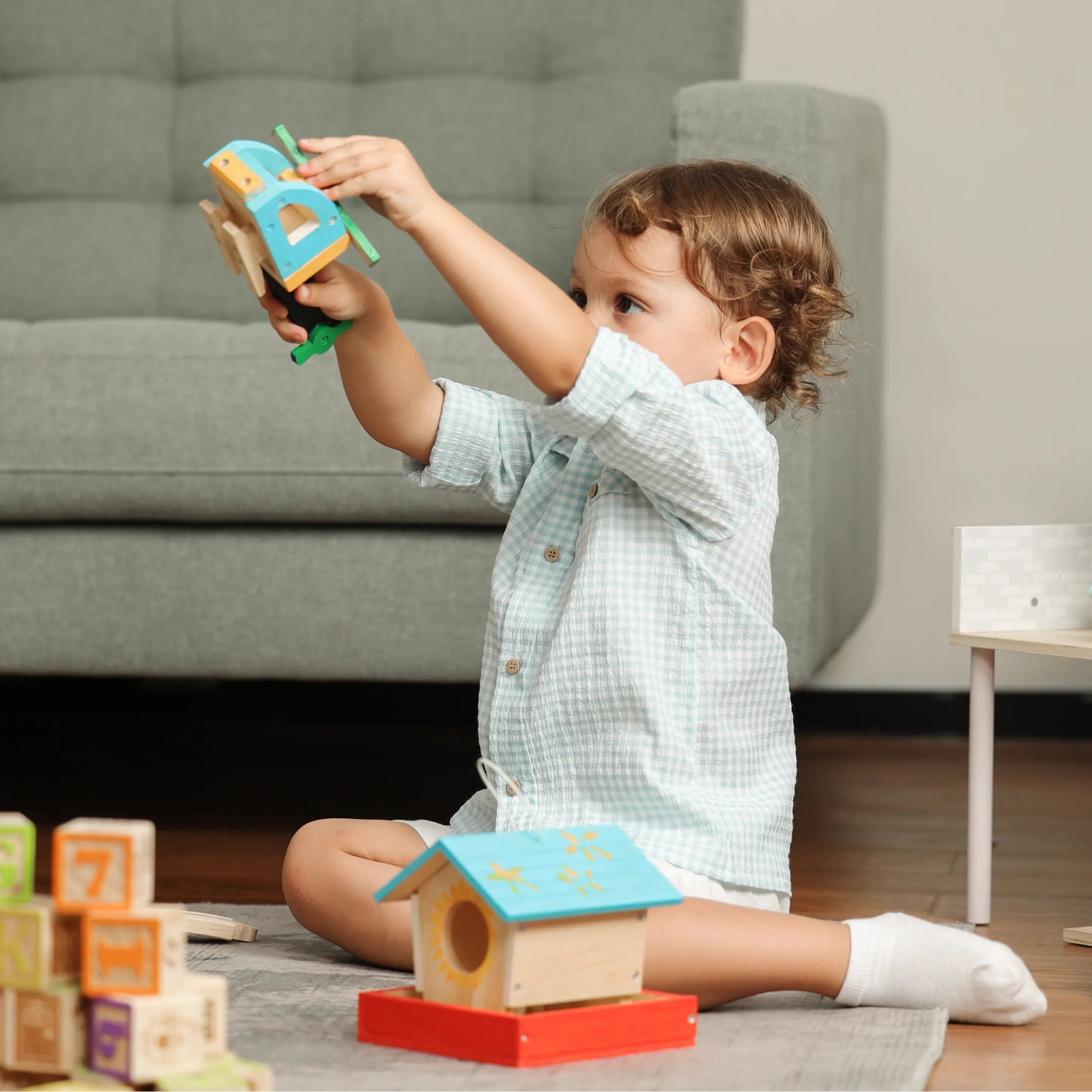 Child playing with toys in a living room
