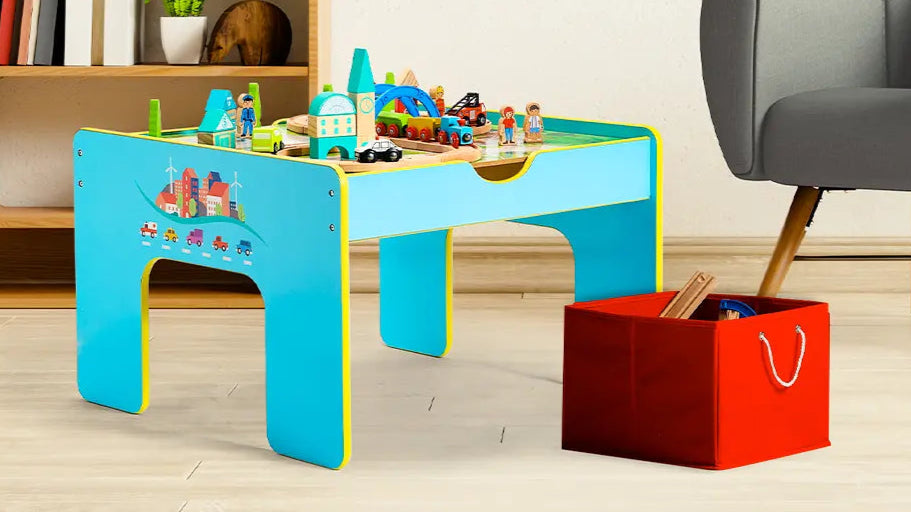 Children's play table with toys, red storage box, and gray chair in a room setting.
