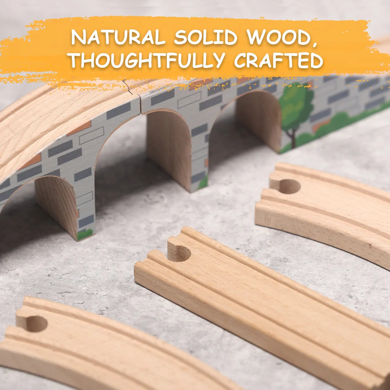 Wooden train tracks with a bridge on a gray surface, featuring text about natural solid wood.