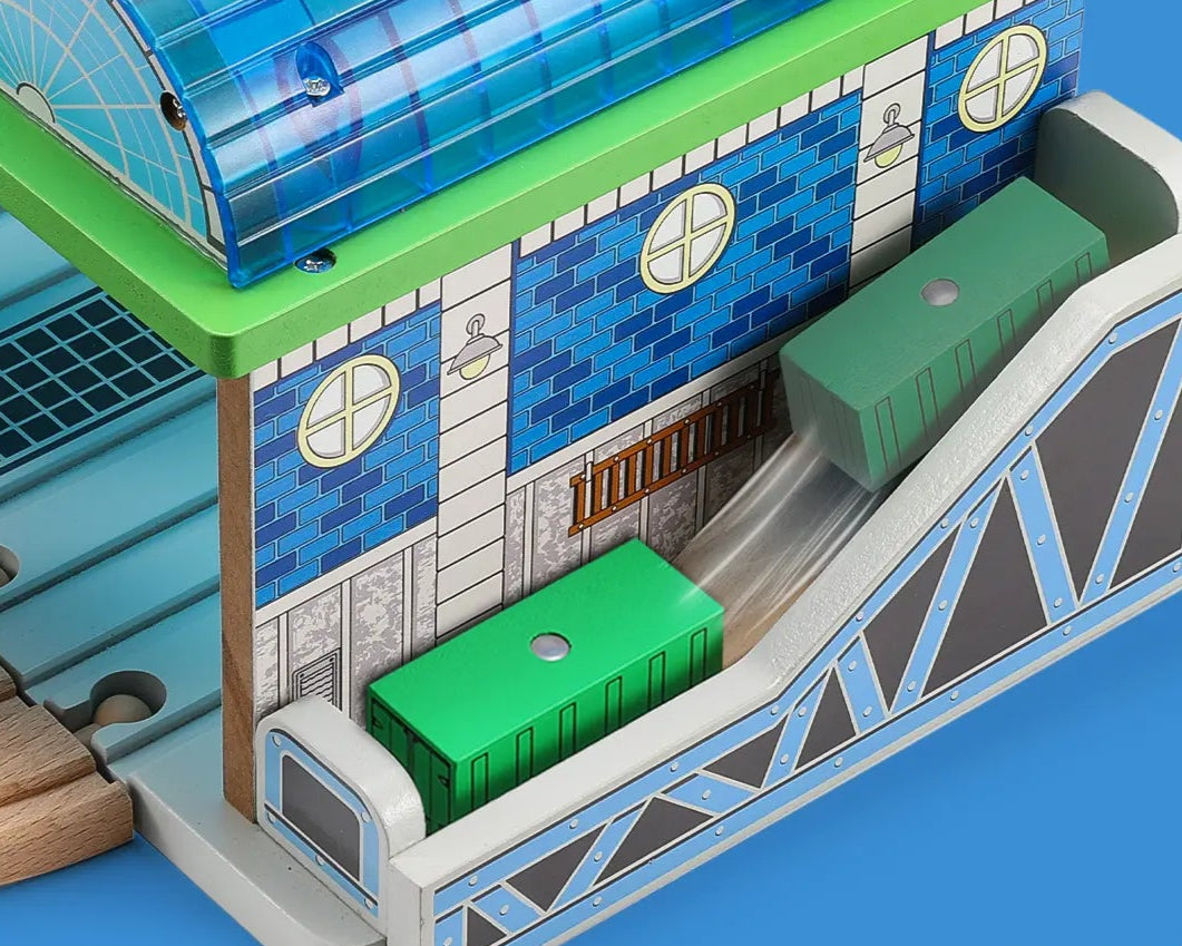 Toy station model with conveyor belts and chutes for item transport and baggage loading.