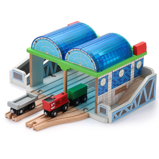 Toy train station with a red train and green cargo car