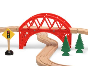 Wooden train track set with red bridge, traffic light, and trees