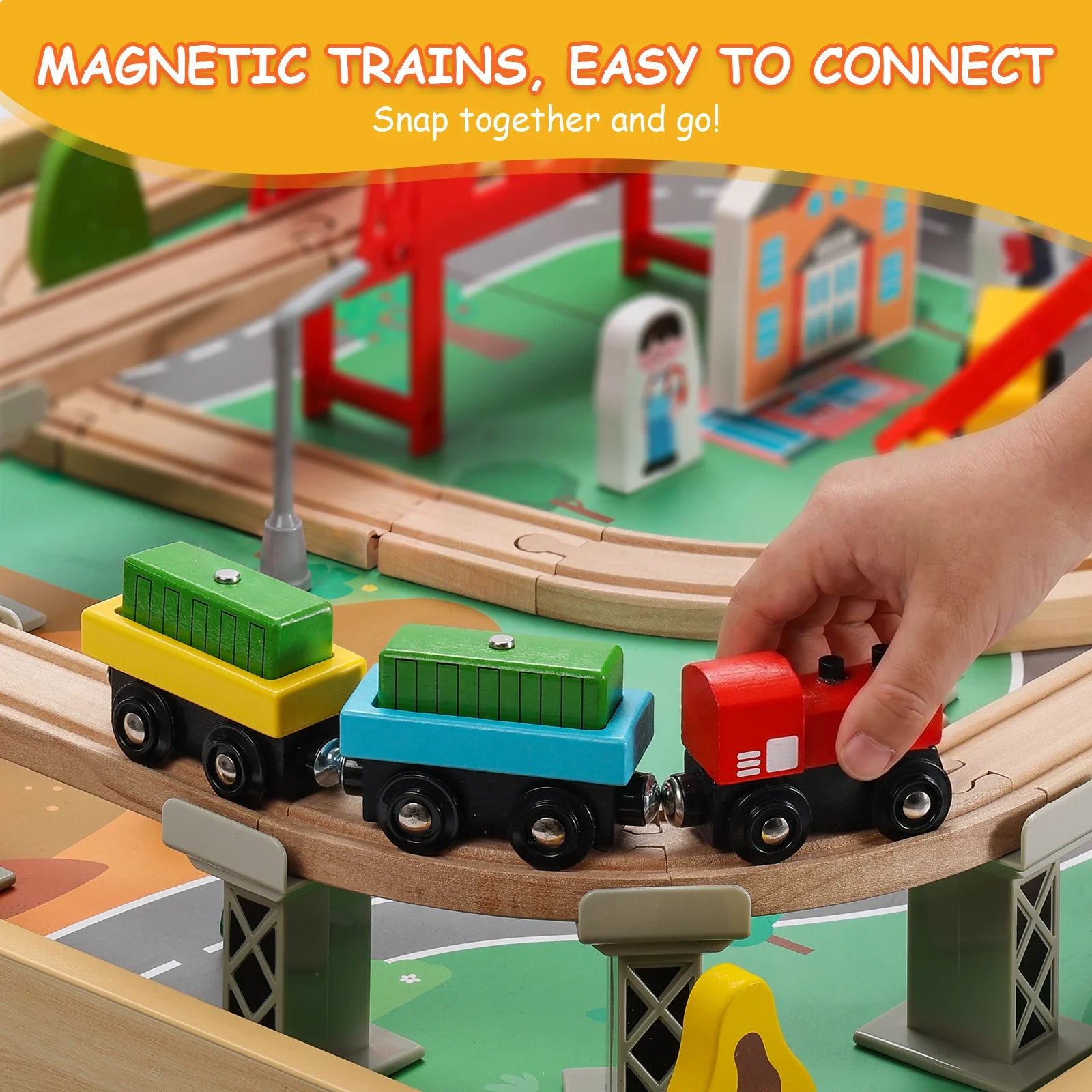 Toy train set with wooden tracks and colorful trains, featuring a hand interacting with the toys.