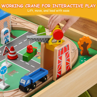Wooden toy crane set with a hand lifting the crane over a toy truck on a wooden track.