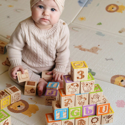 Baby playing with colorful wooden blocks 