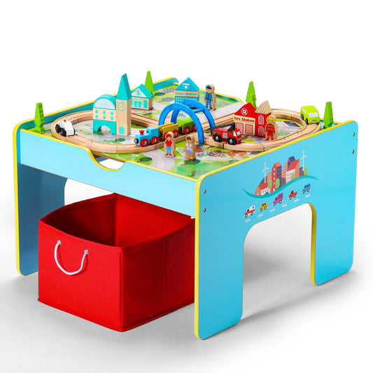 Children's toy train set on a colorful table with a red storage box.