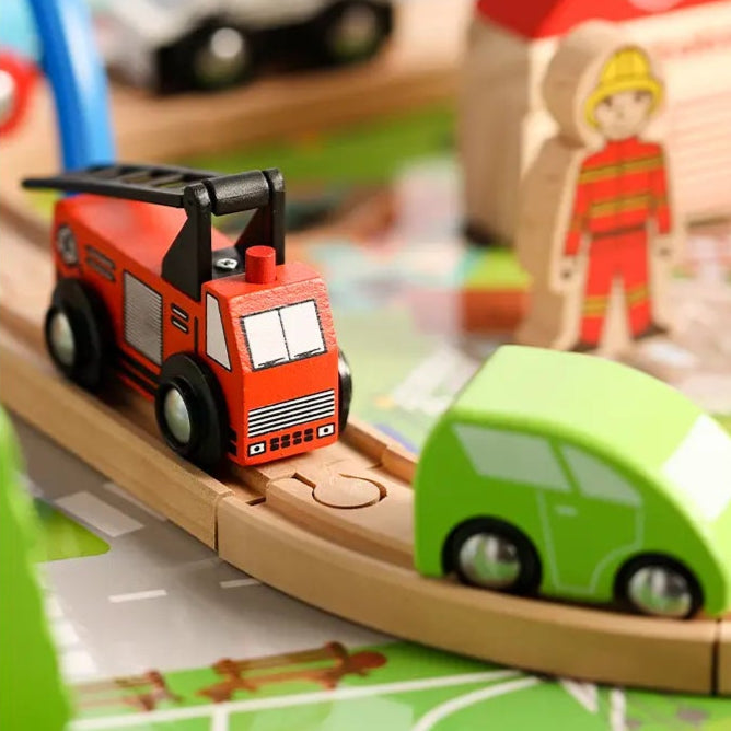 Toy train set with various buildings and vehicles