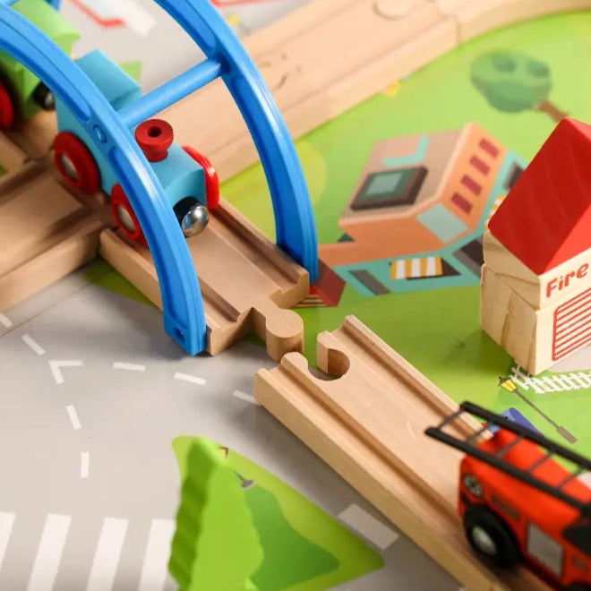 Toy train set with various buildings and vehicles