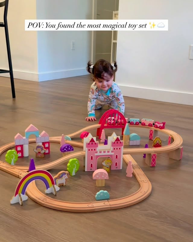 Child playing with a toy train set