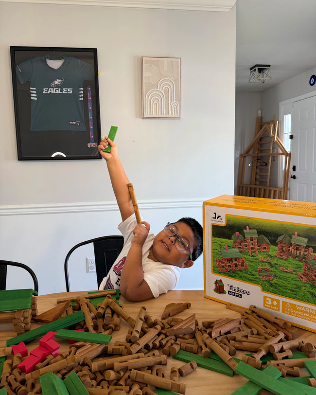 Child playing with wooden building blocks- Compatible with Lincoln Logs