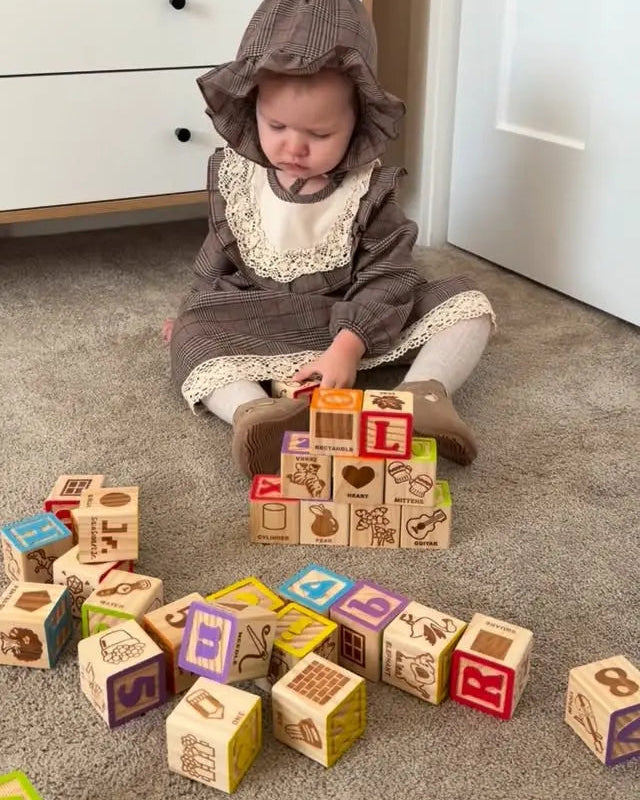 Child playing with wooden blocks on a carpeted floor